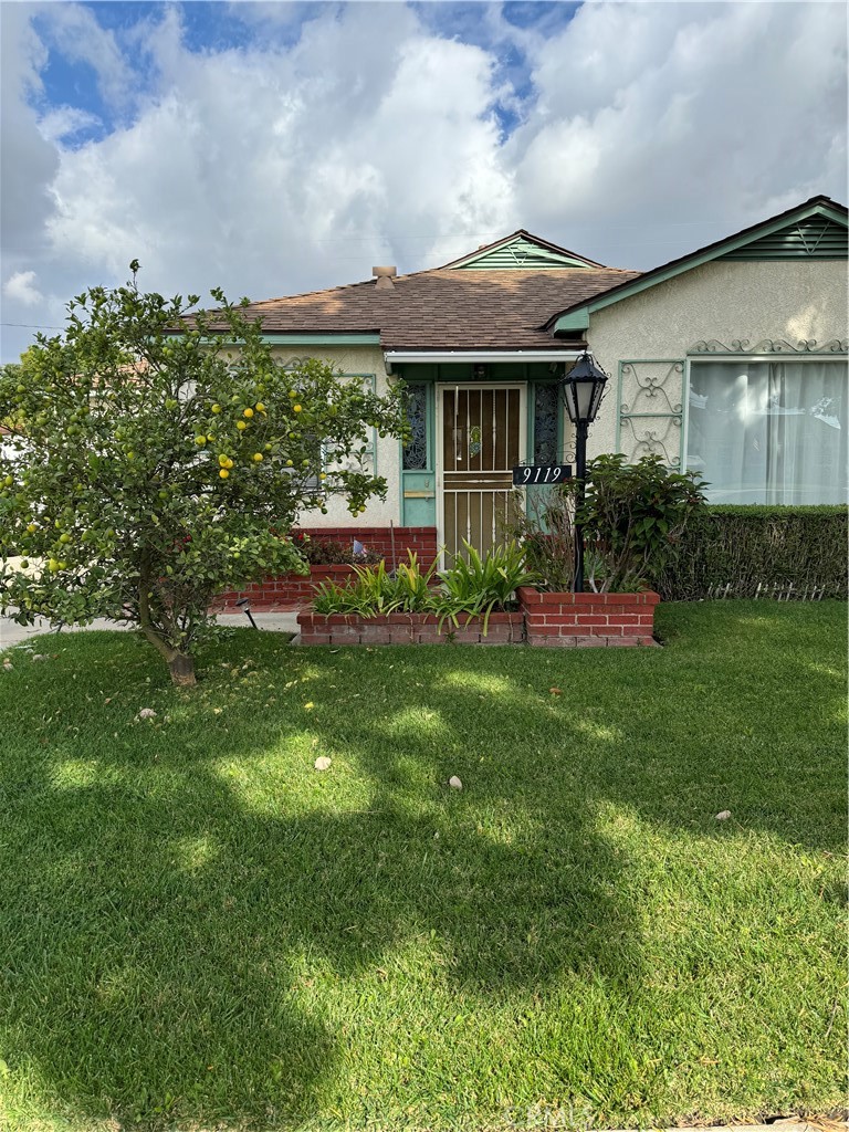 a front view of a house with a garden and porch