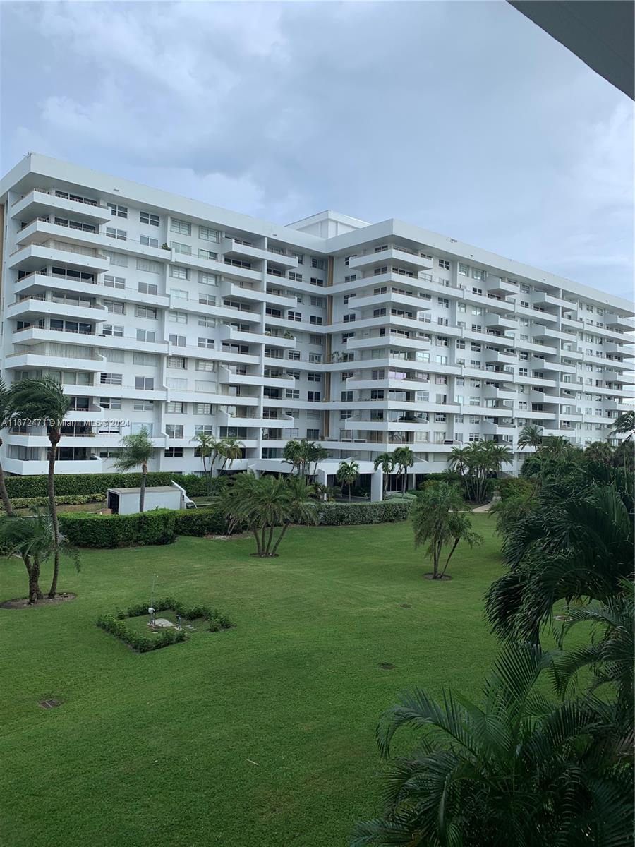 a view of a big building with a yard