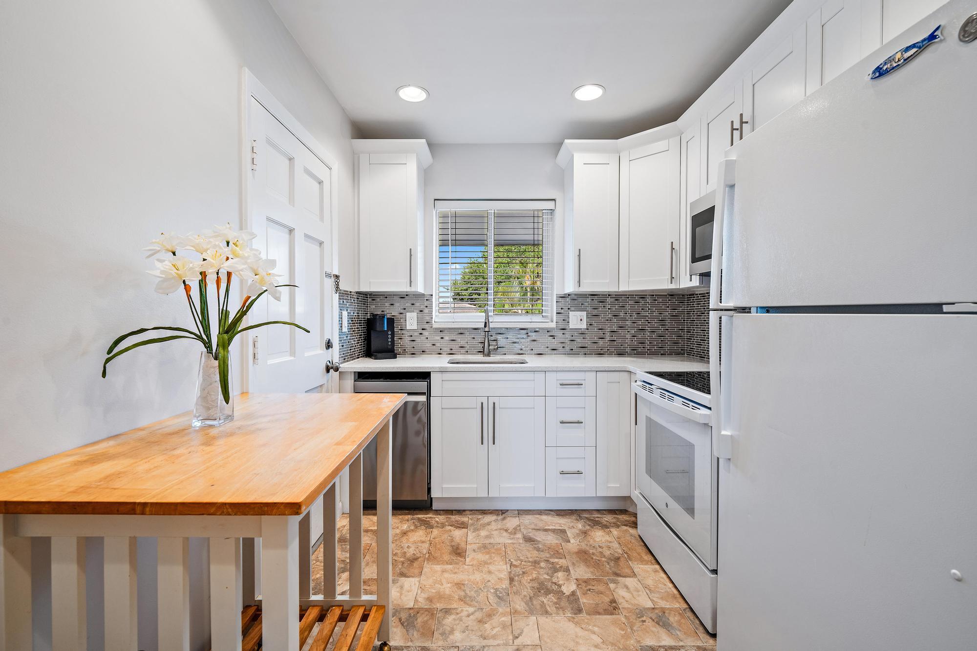 a kitchen with stainless steel appliances granite countertop a refrigerator sink and cabinets