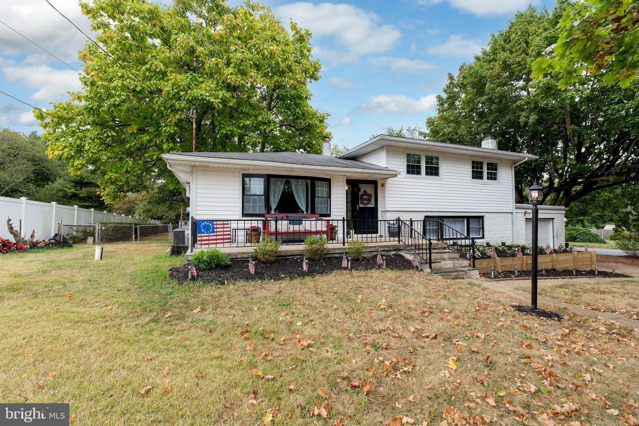 a view of a house with a yard patio and a slide