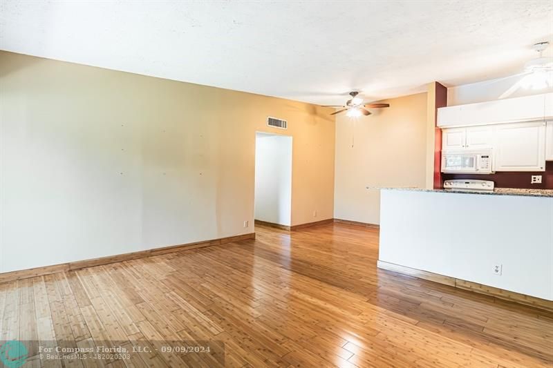 a view of a kitchen with wooden floor