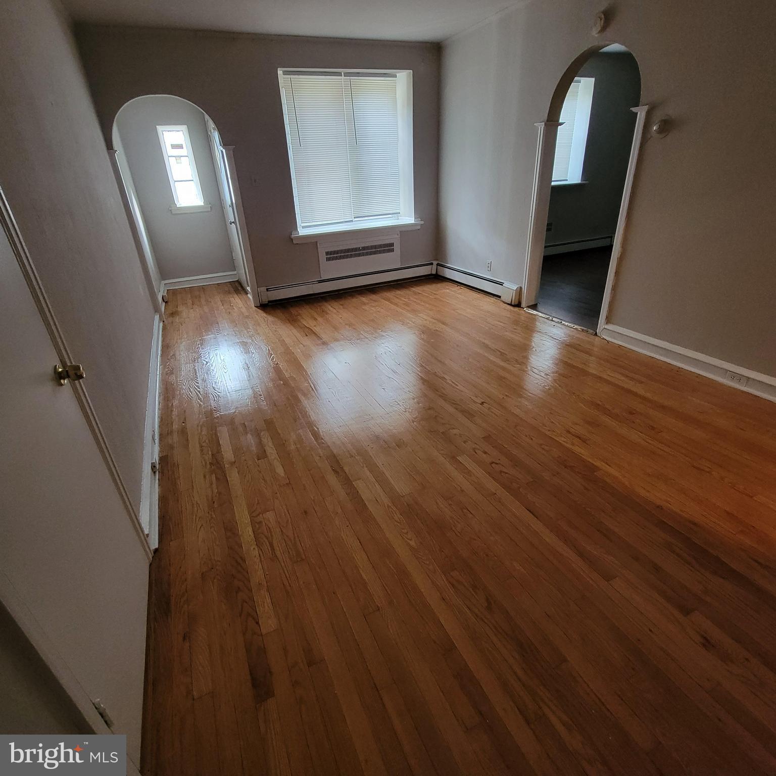 wooden floor in a hall with a mirror