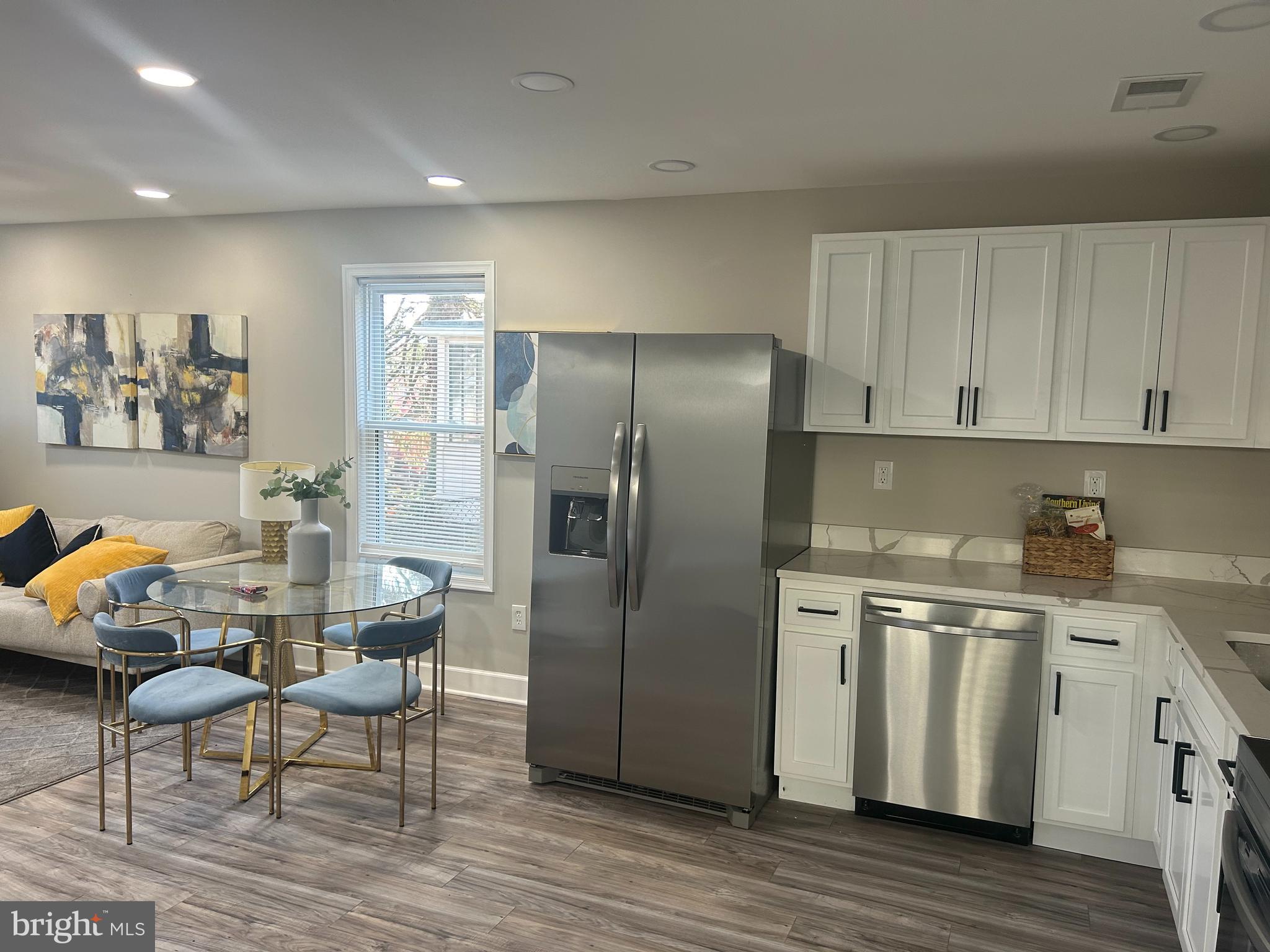 a kitchen with granite countertop a refrigerator and a stove top oven