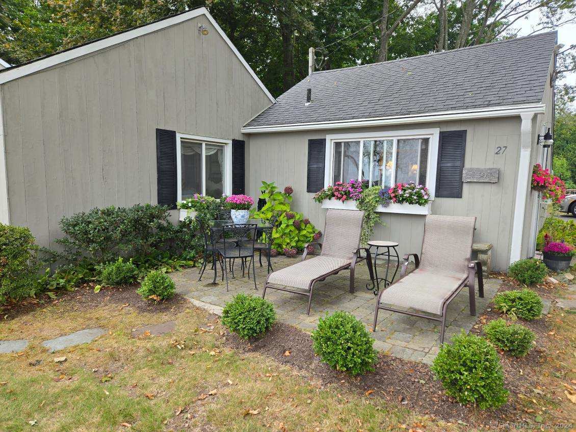 a view of a house with sitting area and a garden