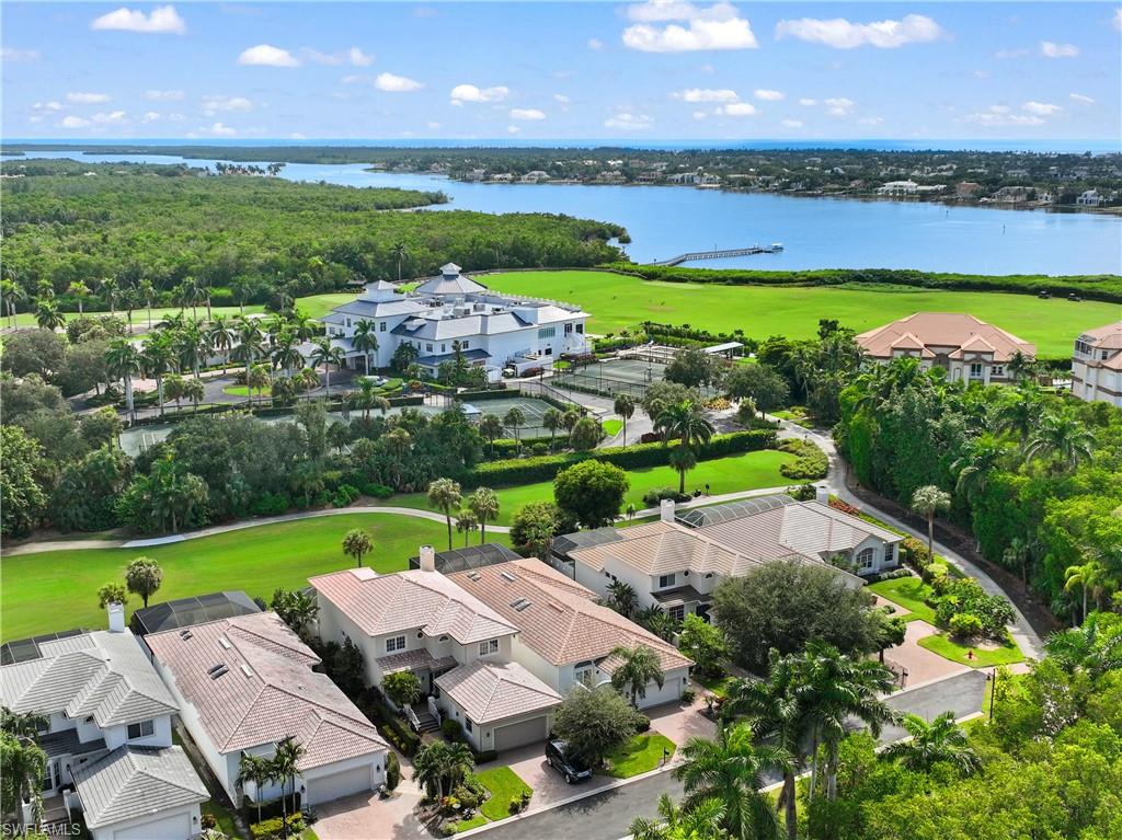 an aerial view of a residential houses with outdoor space and lake view