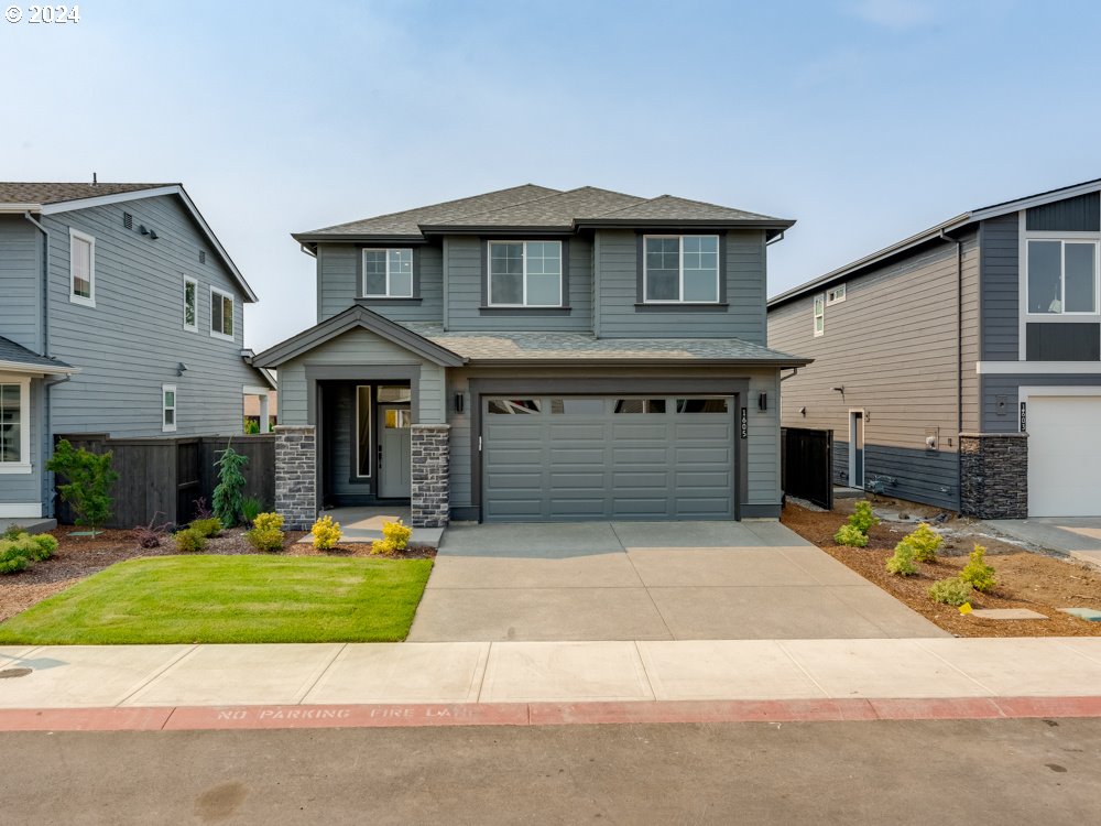 a front view of a house with a yard and garage