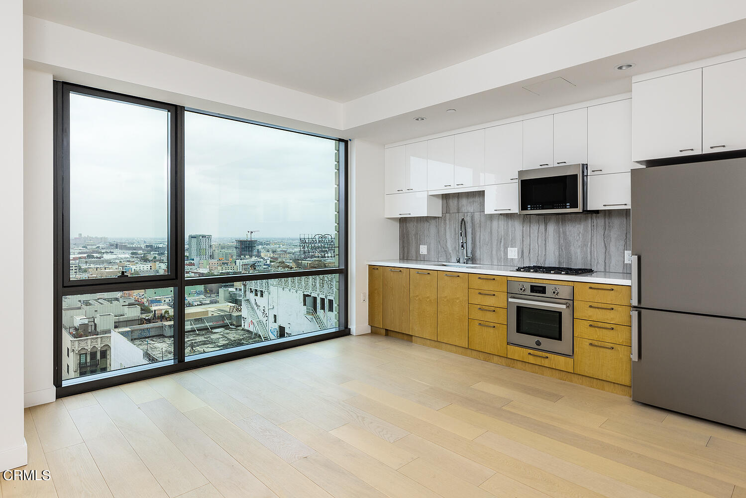 a kitchen with stainless steel appliances a stove top oven a sink and a refrigerator