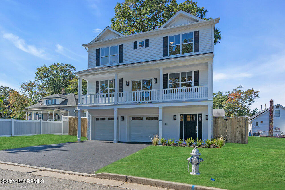 a front view of a house with a garden and yard