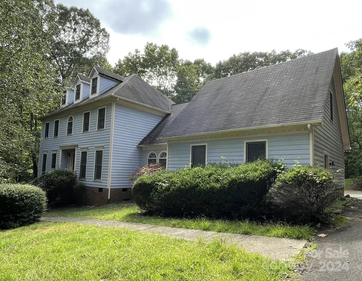 a view of a house with a garden and plants