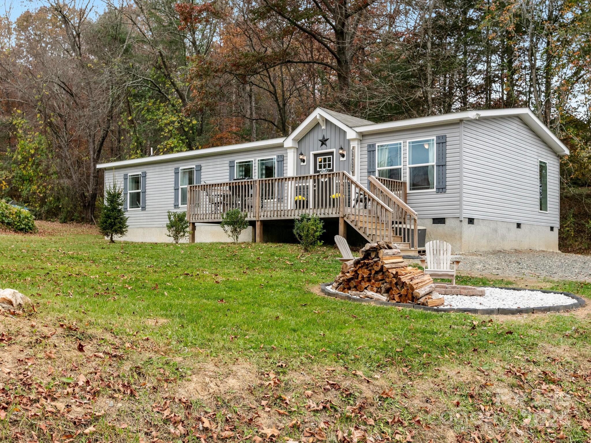 a front view of a house with a yard and trees