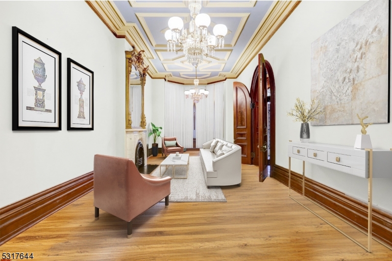 a living room with furniture and a chandelier