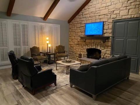 a living room with furniture wooden floor and a fireplace