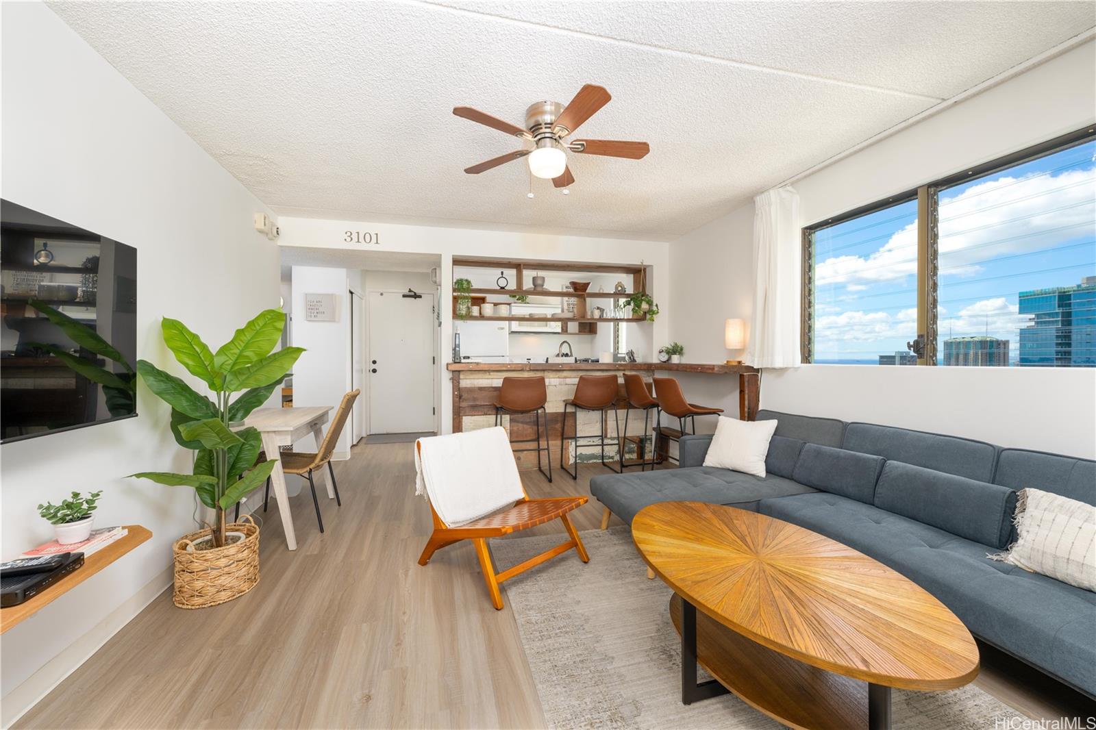 a living room with furniture and a large window