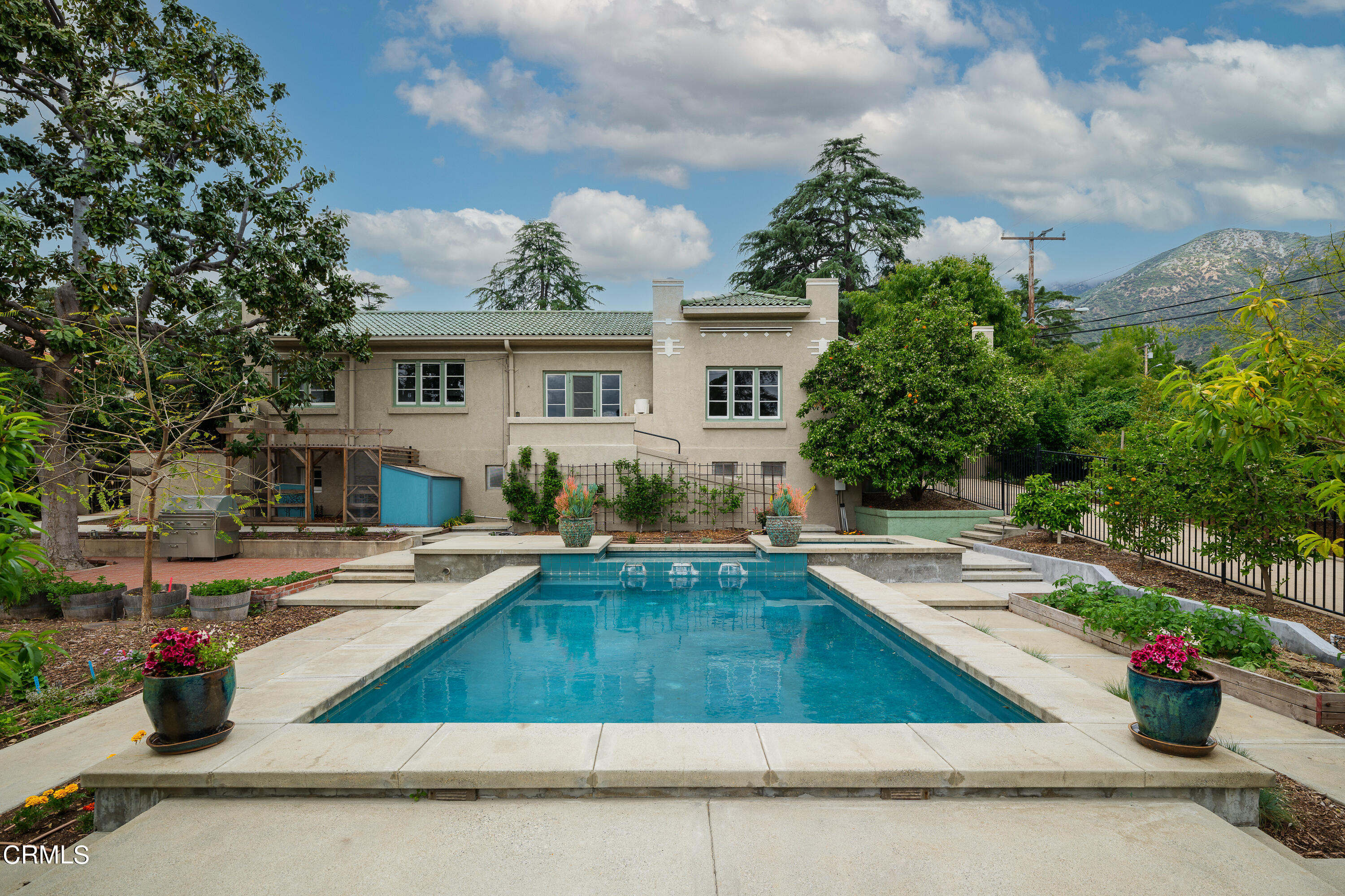 a view of a house with swimming pool and sitting area