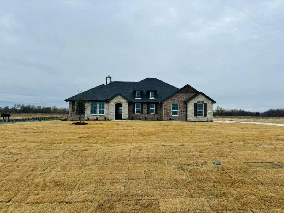 a front view of a house with a yard