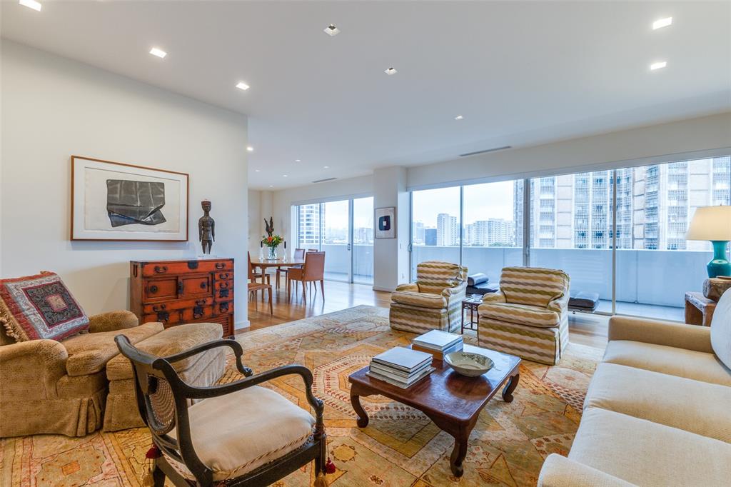 a living room with furniture and a floor to ceiling window