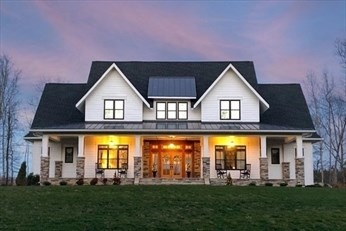 a front view of house with an outdoor space and seating