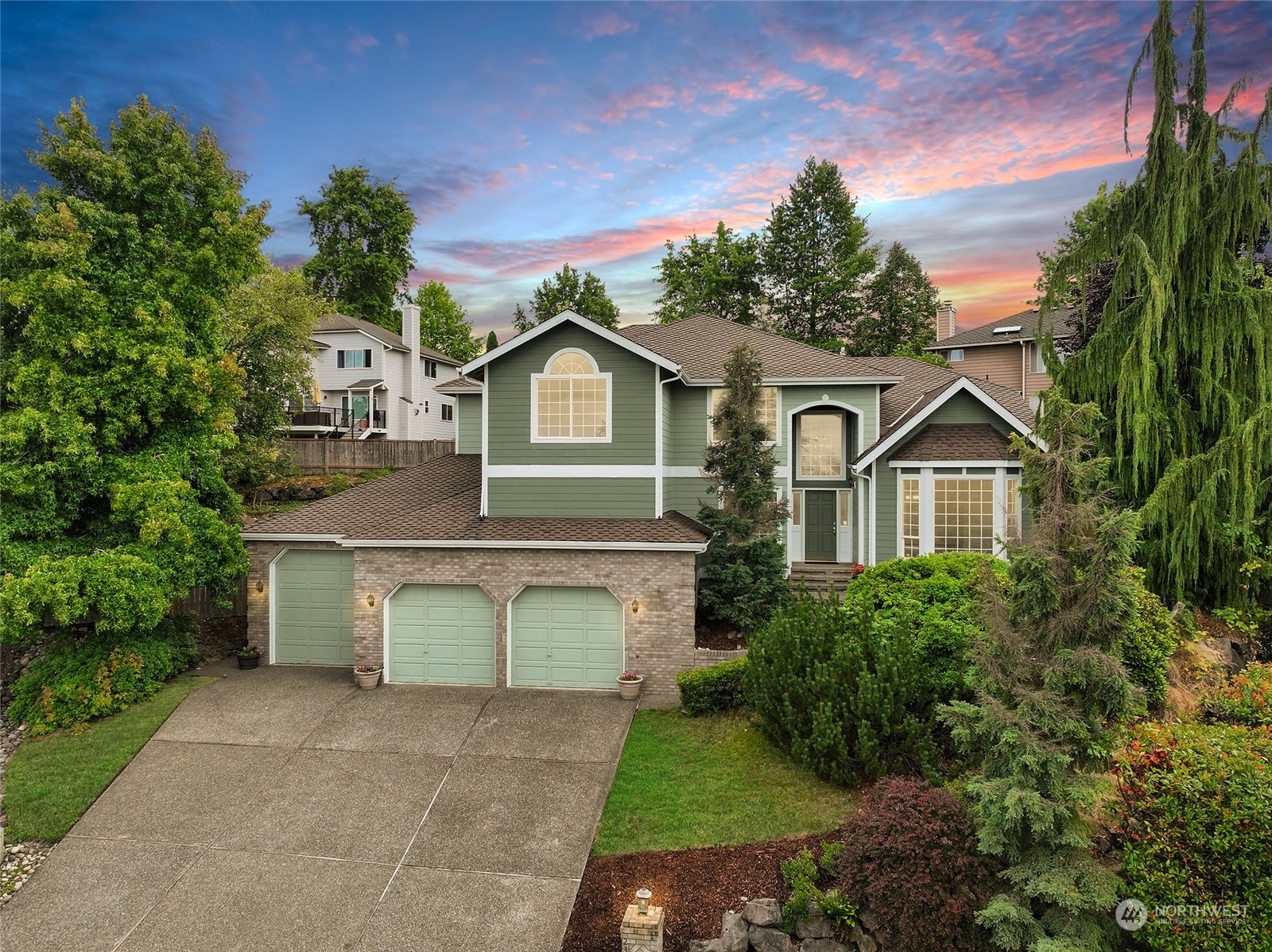 a front view of a house with a yard and garage