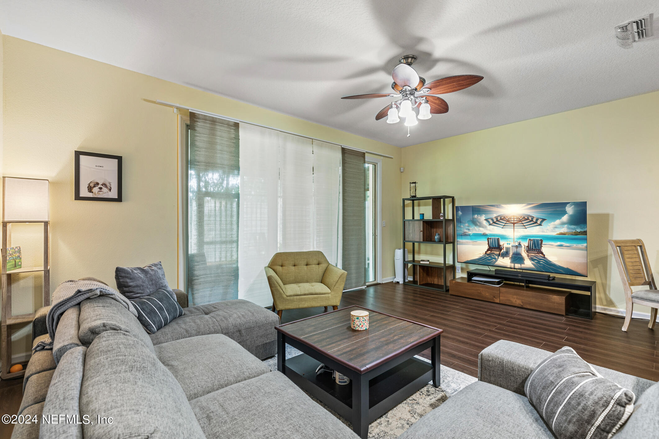 a living room with furniture and a flat screen tv