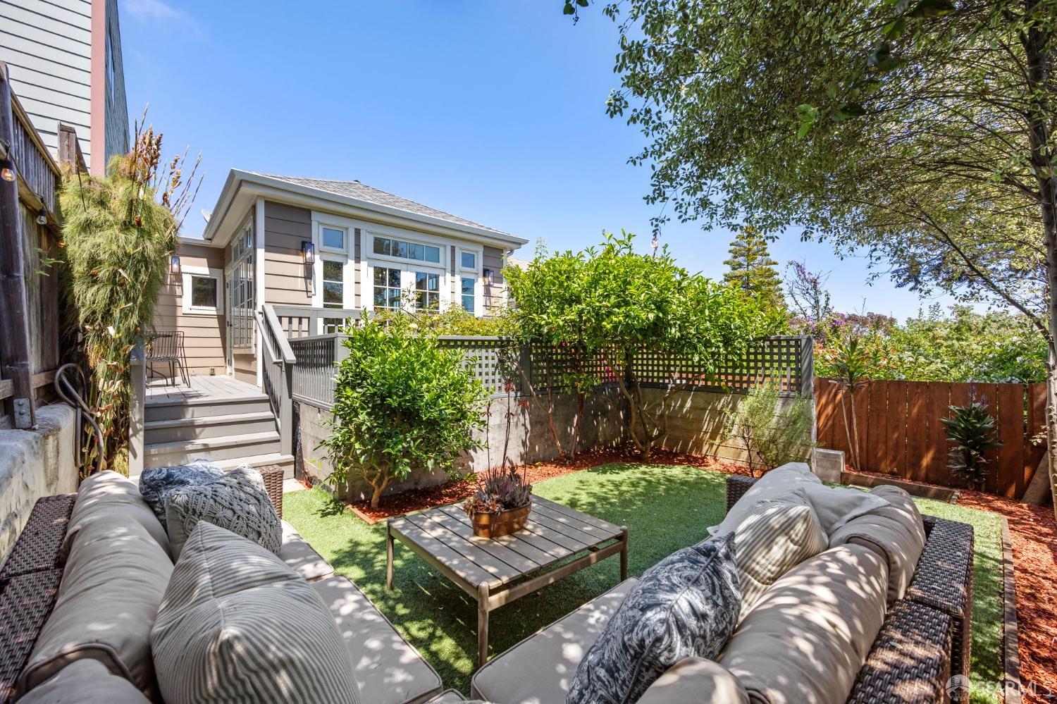 a view of backyard of house with outdoor seating