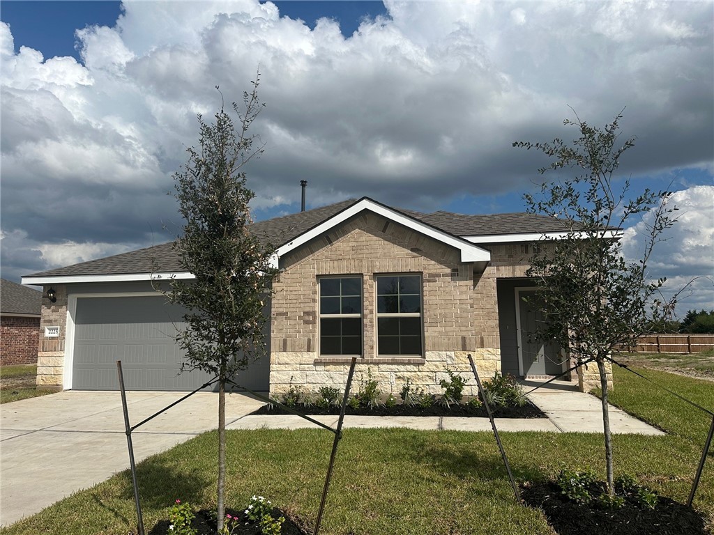 a front view of a house with garden