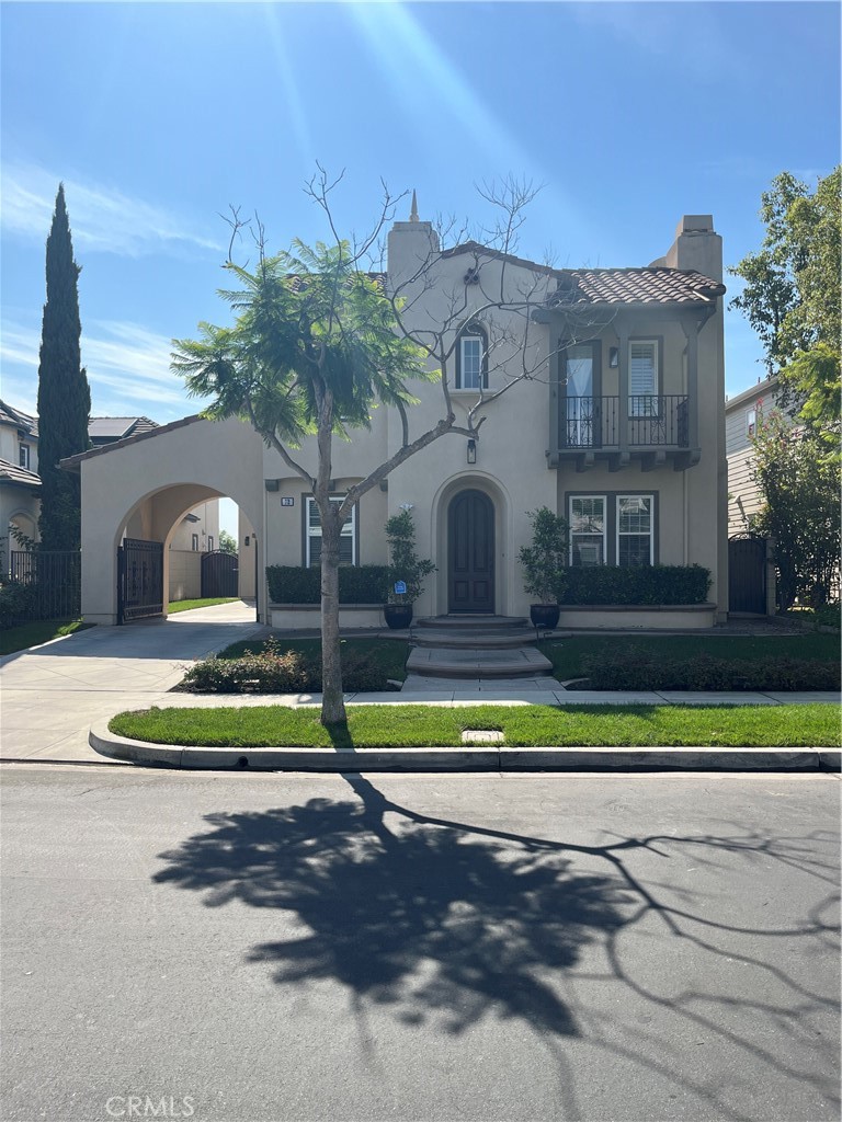 a view of a house with a yard and palm trees