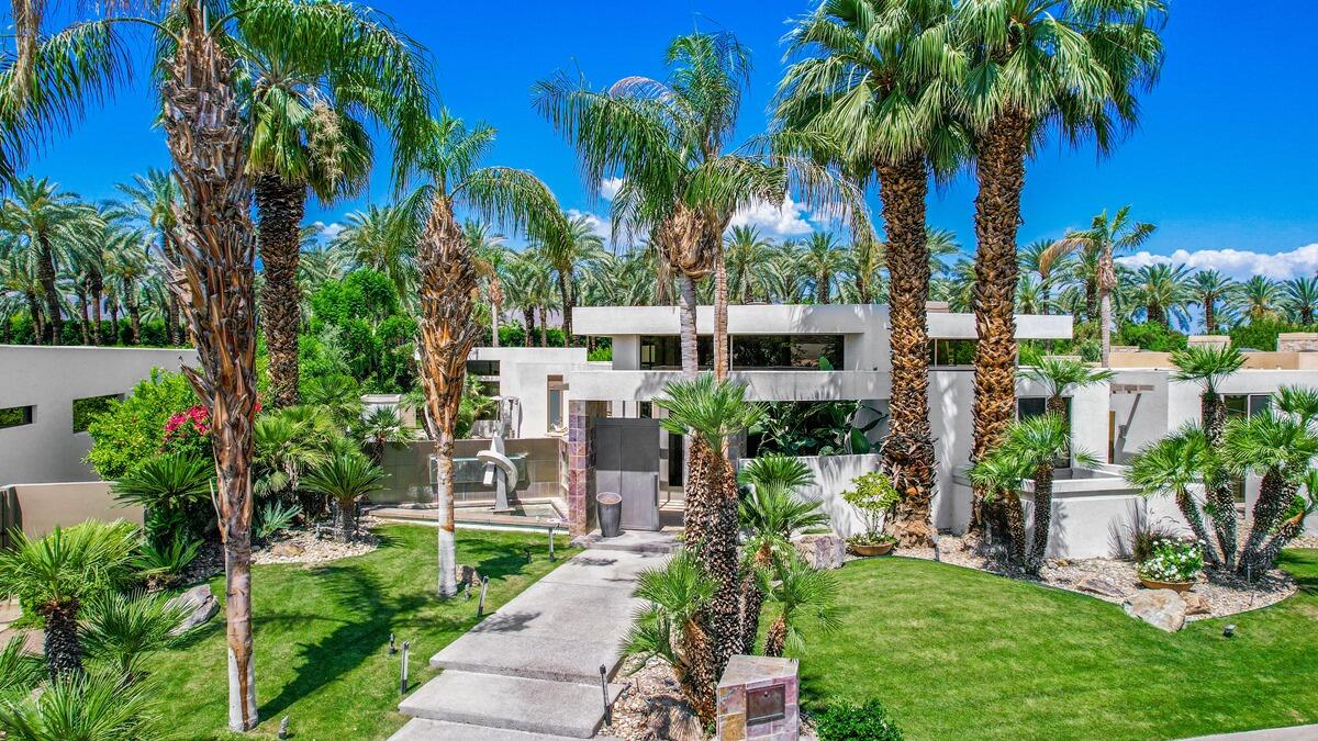 a view of a yard with palm trees