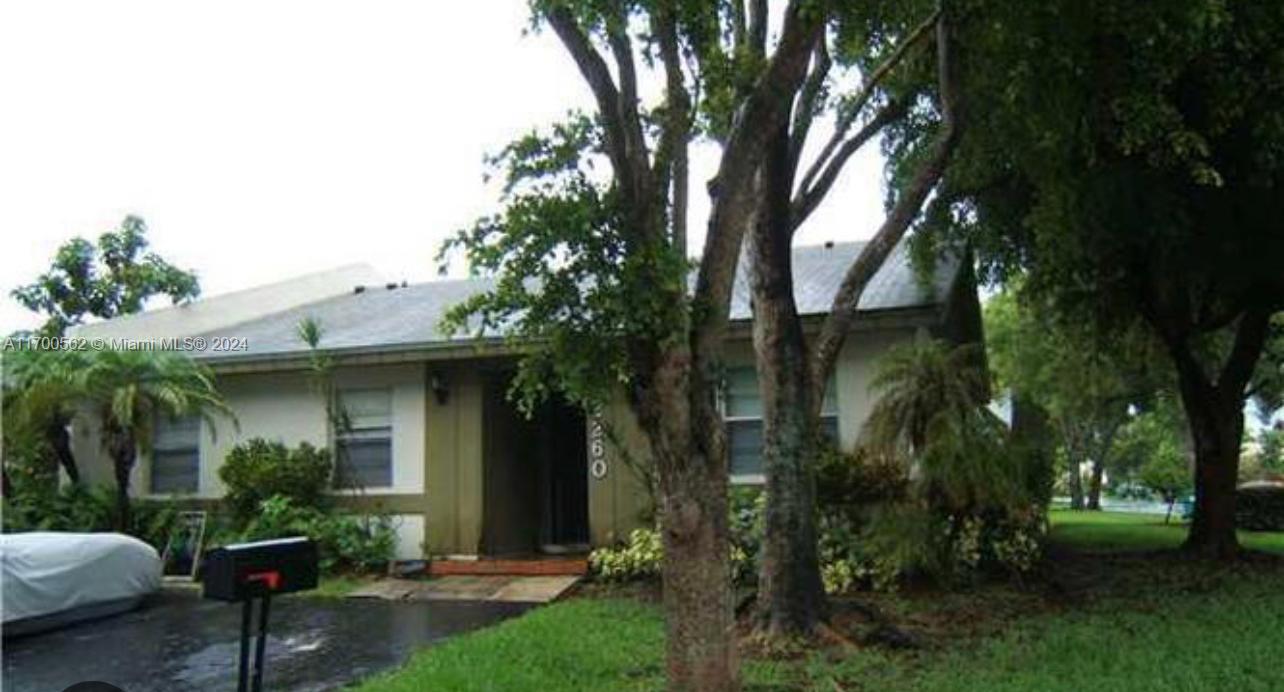 a view of a house with a yard and tree s