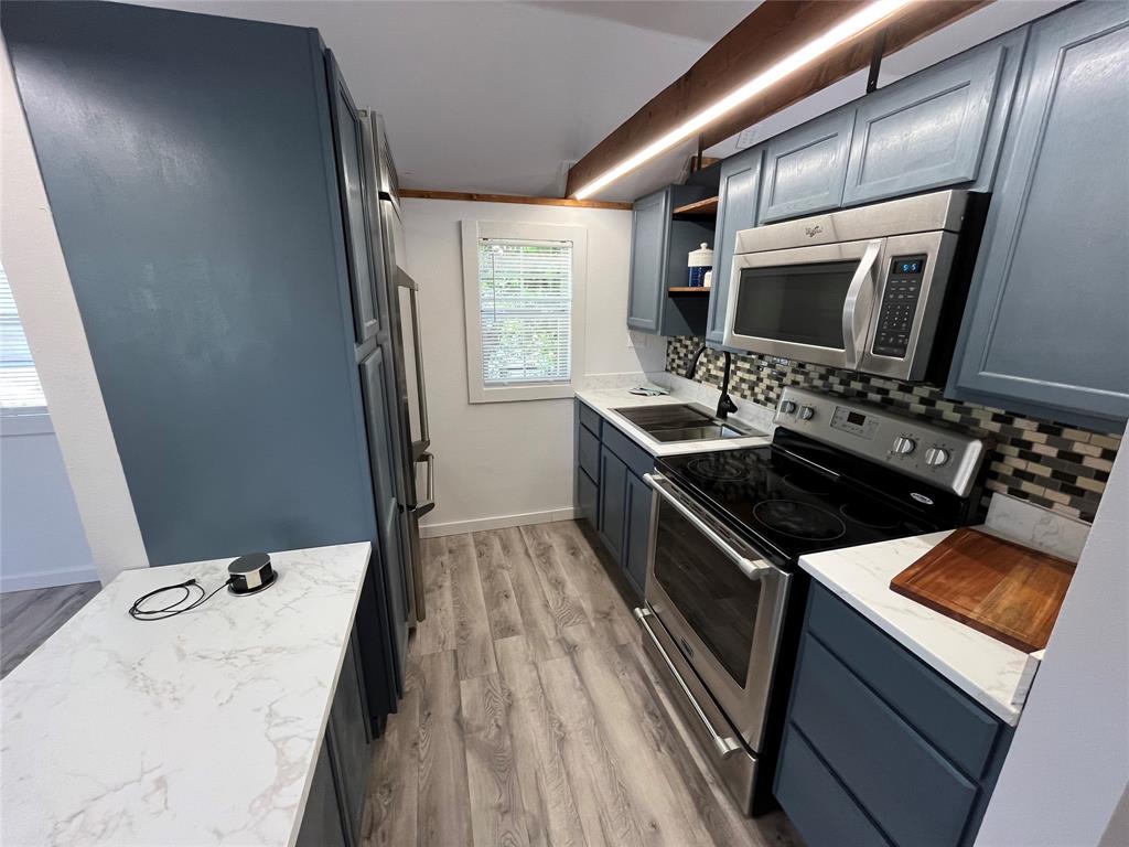 a kitchen that has a sink and a stove