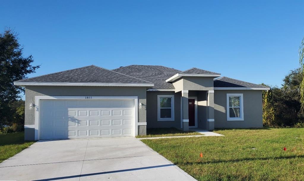 a front view of a house with a yard and garage