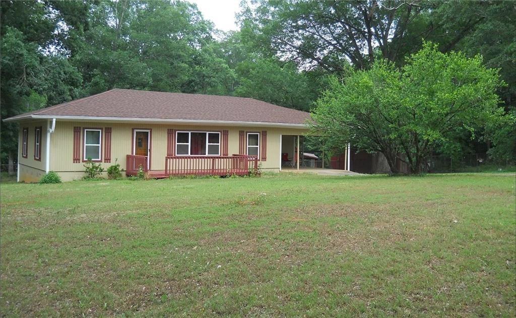 a front view of house with yard and green space