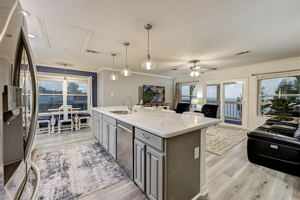 a large kitchen with kitchen island a large island in the center and stainless steel appliances