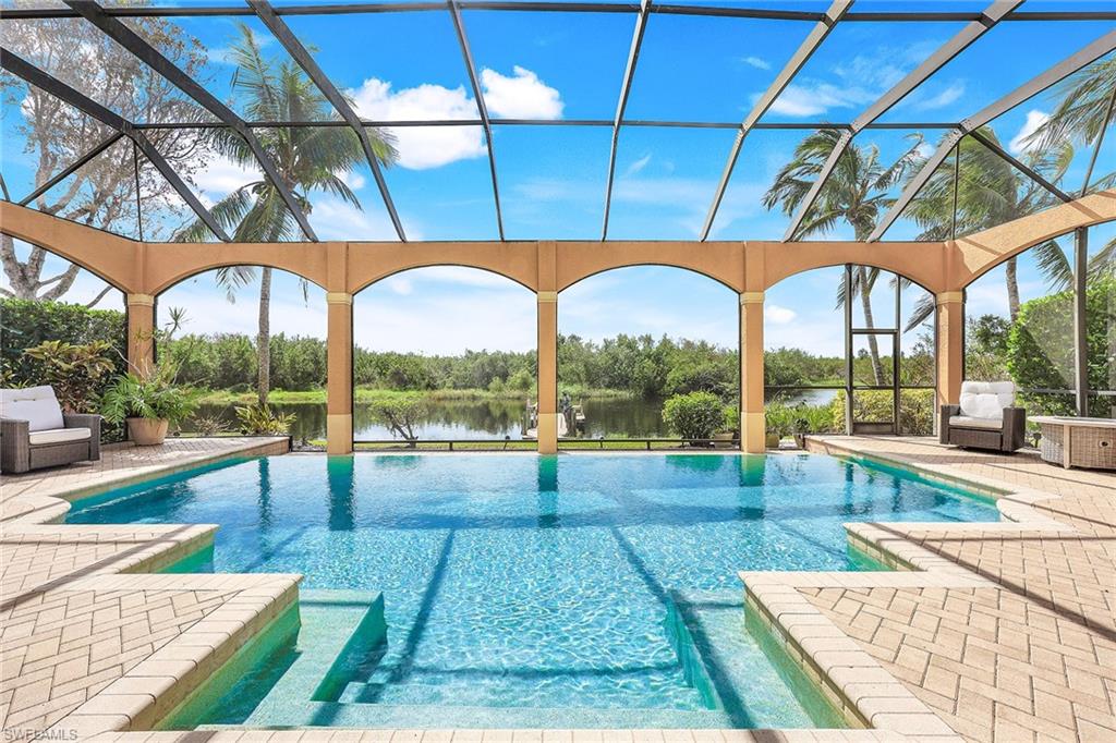 a view of swimming pool with a couches in patio