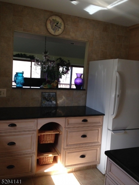 a kitchen with a refrigerator and a microwave