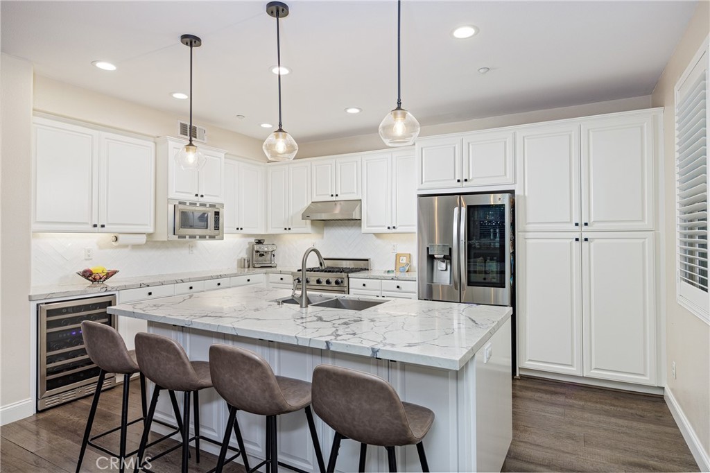 a kitchen with kitchen island granite countertop a sink a center island and cabinets