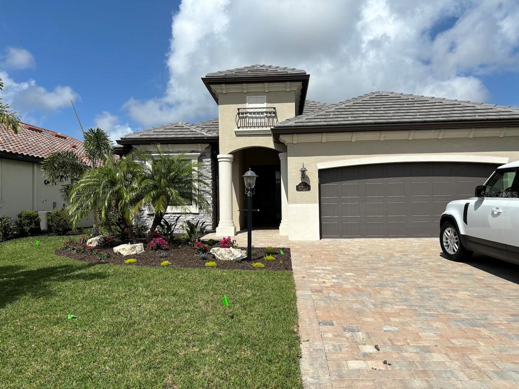 a front view of a house with garden