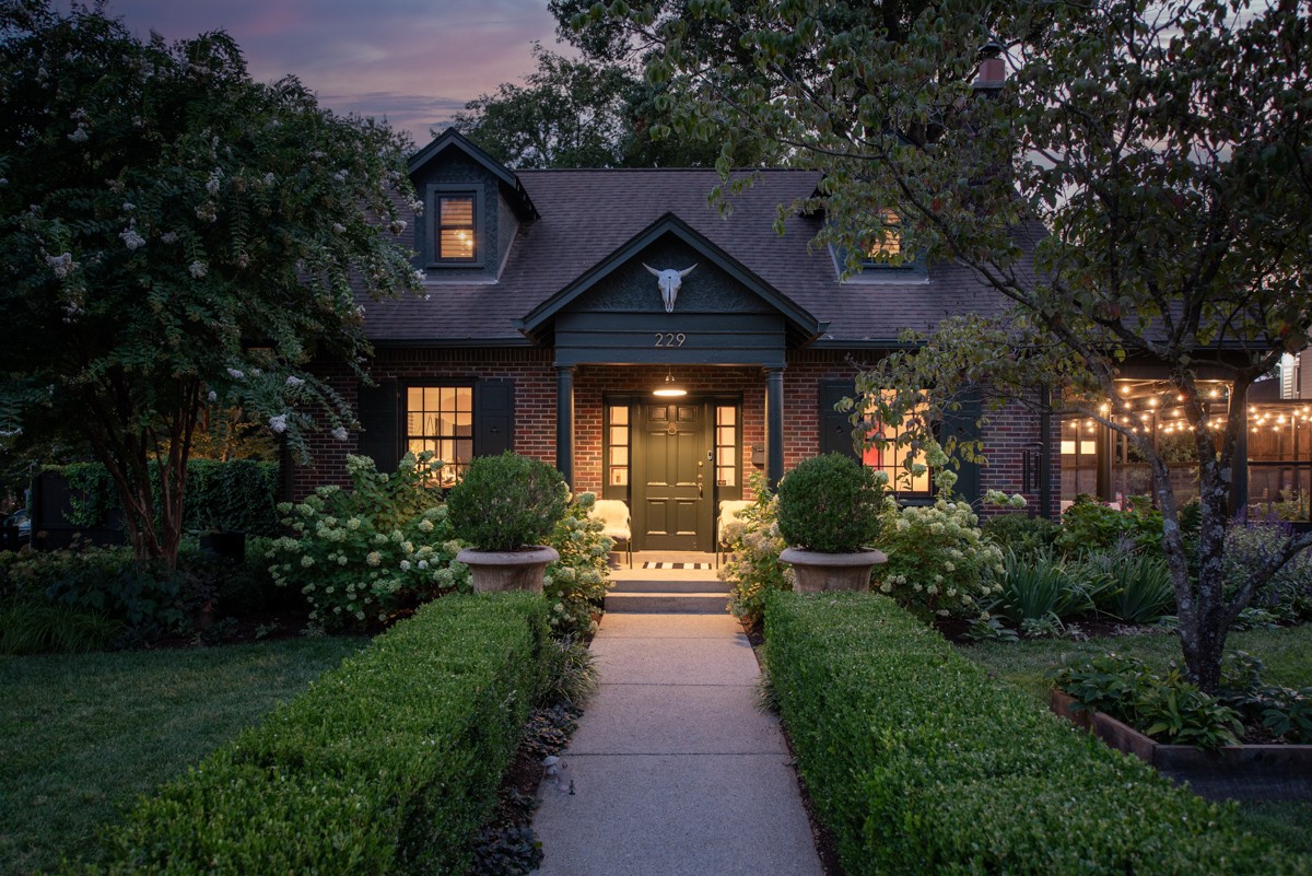 a front view of a house with garden