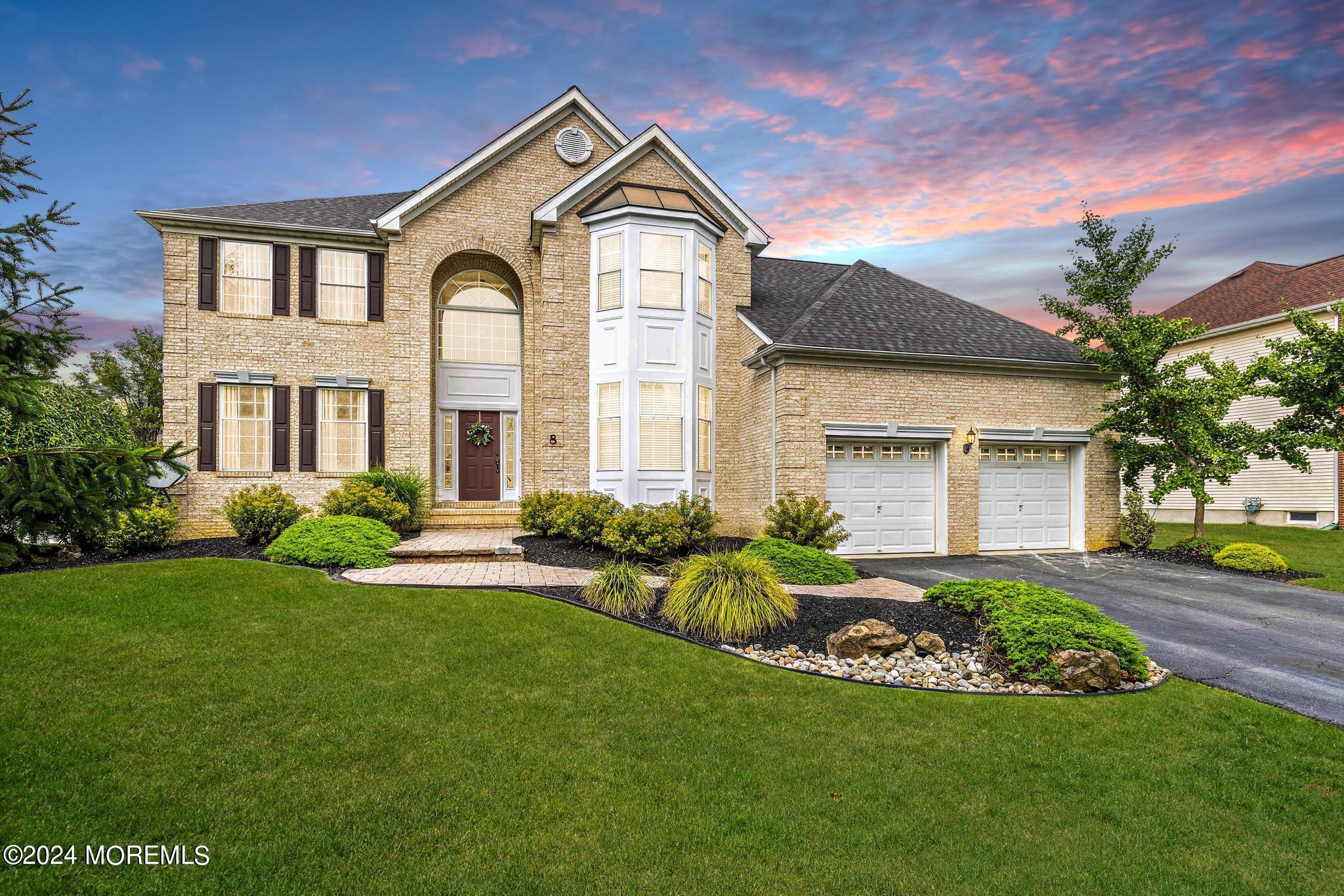 a front view of a house with a yard