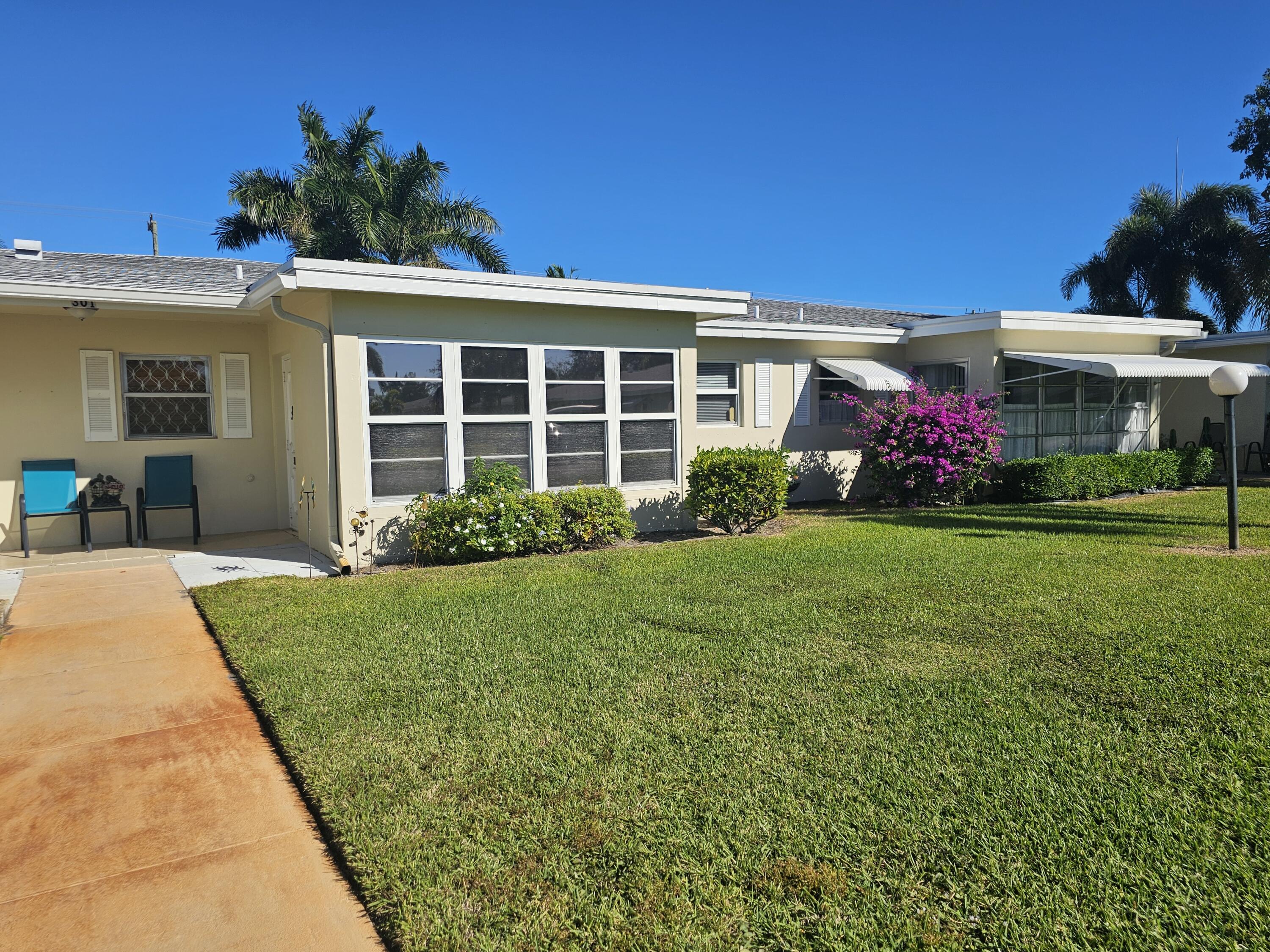 a view of a house with garden and yard