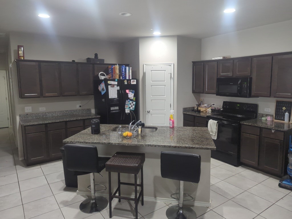 a kitchen with stainless steel appliances granite countertop a sink counter space and cabinets