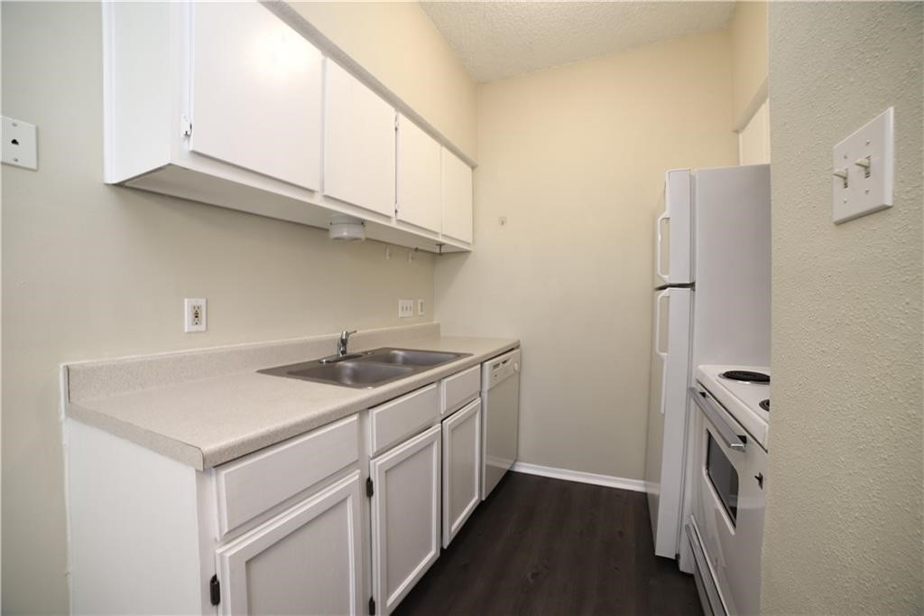 a kitchen with stainless steel appliances granite countertop a sink and a refrigerator