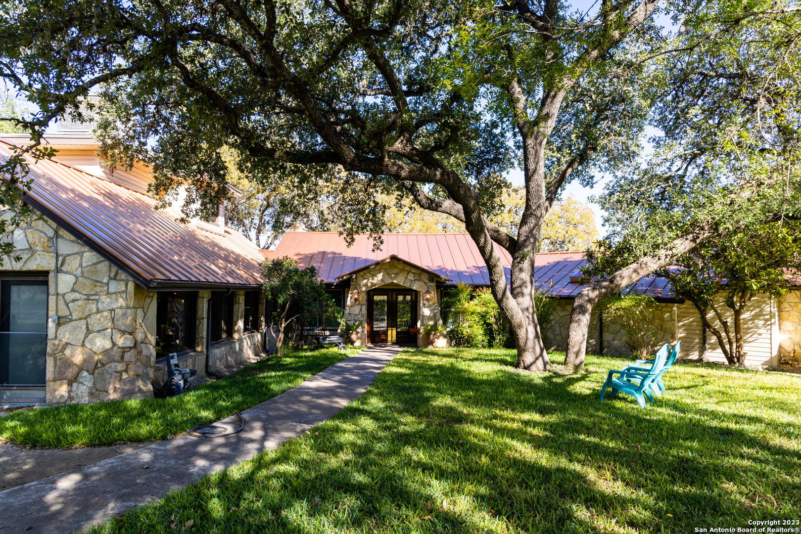 a front view of a house with a yard table and chairs