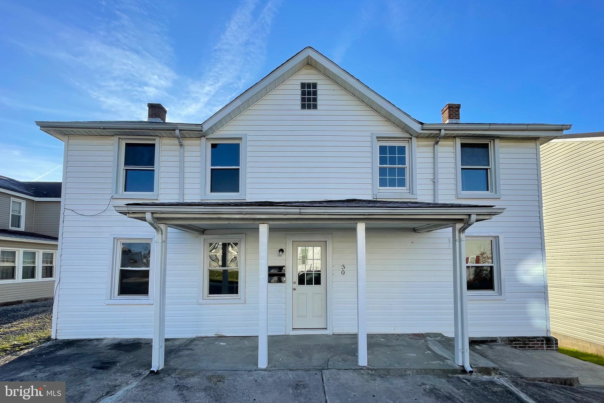 a front view of a house with a wooden fence