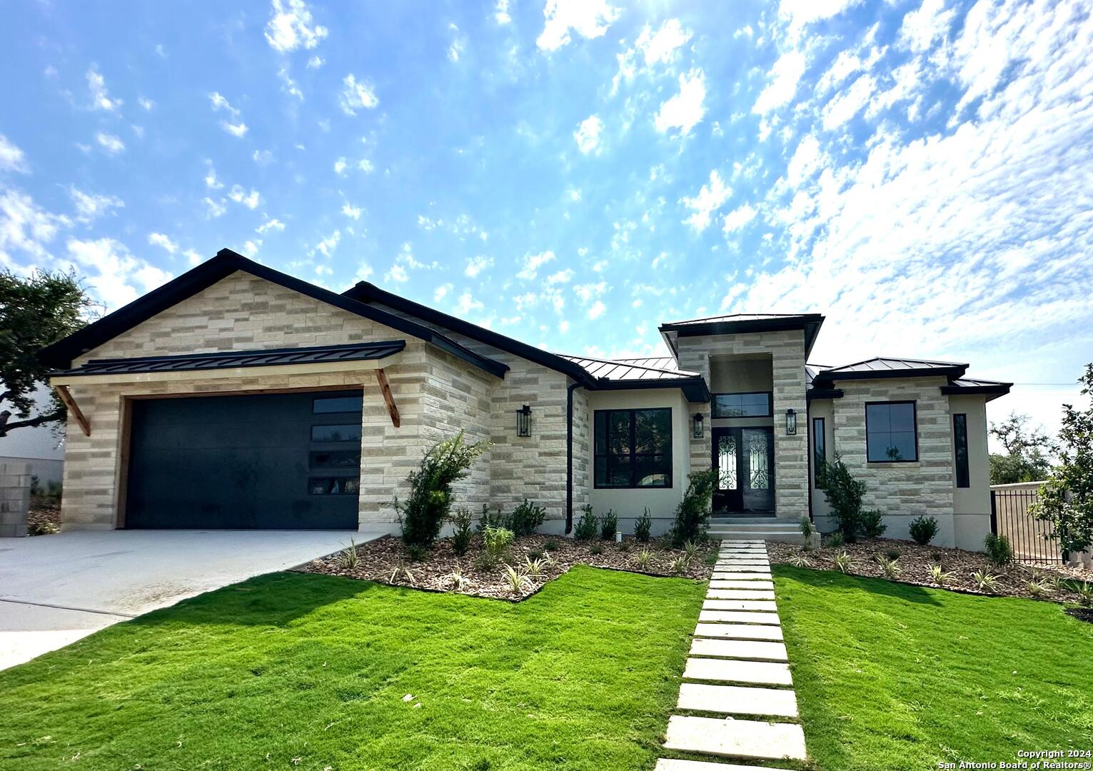 a front view of a house with a yard and garage