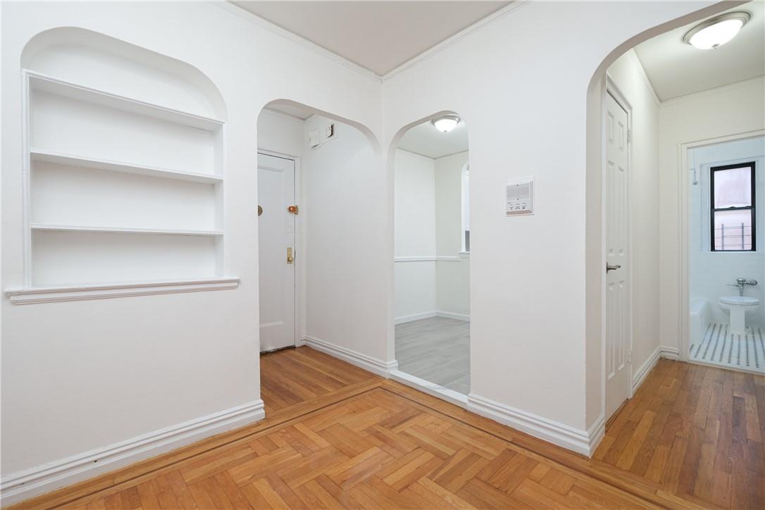 a view of a room with wooden floor