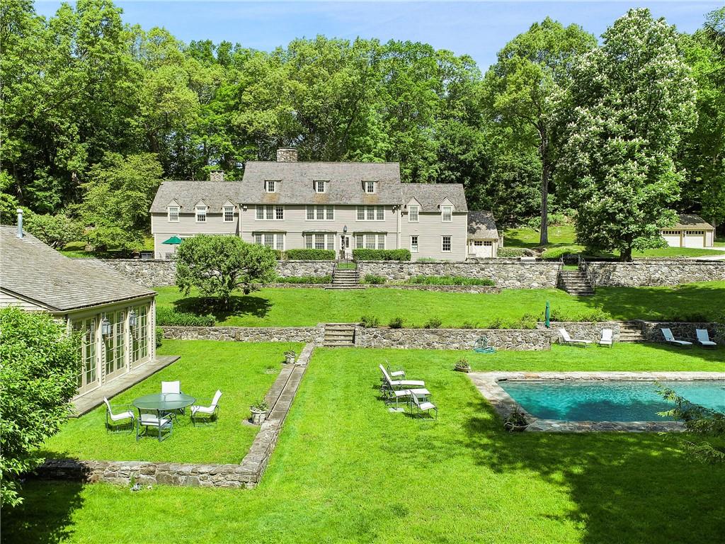 a view of a house with a yard and sitting area