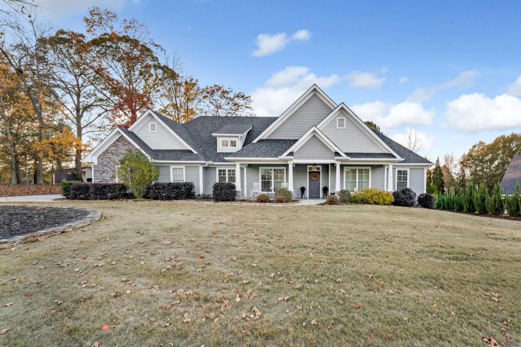 a front view of a house with yard and porch