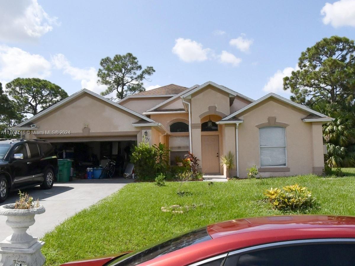 a front view of a house with a yard and garage