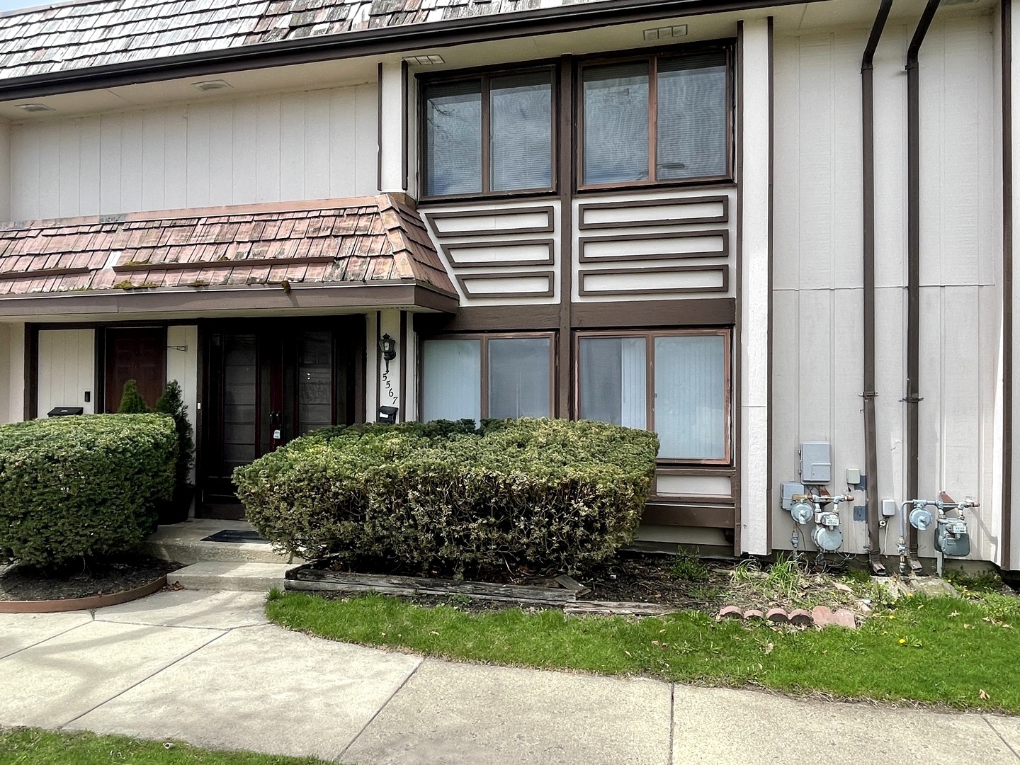 a front view of a house with garden