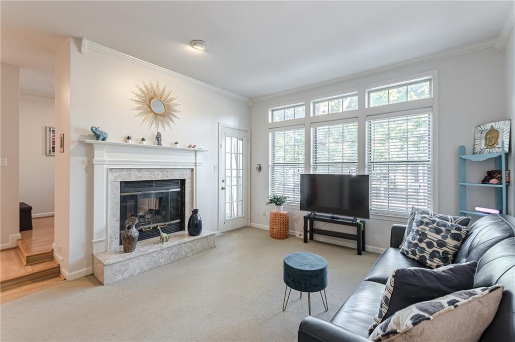 a living room with furniture a fireplace and a flat screen tv